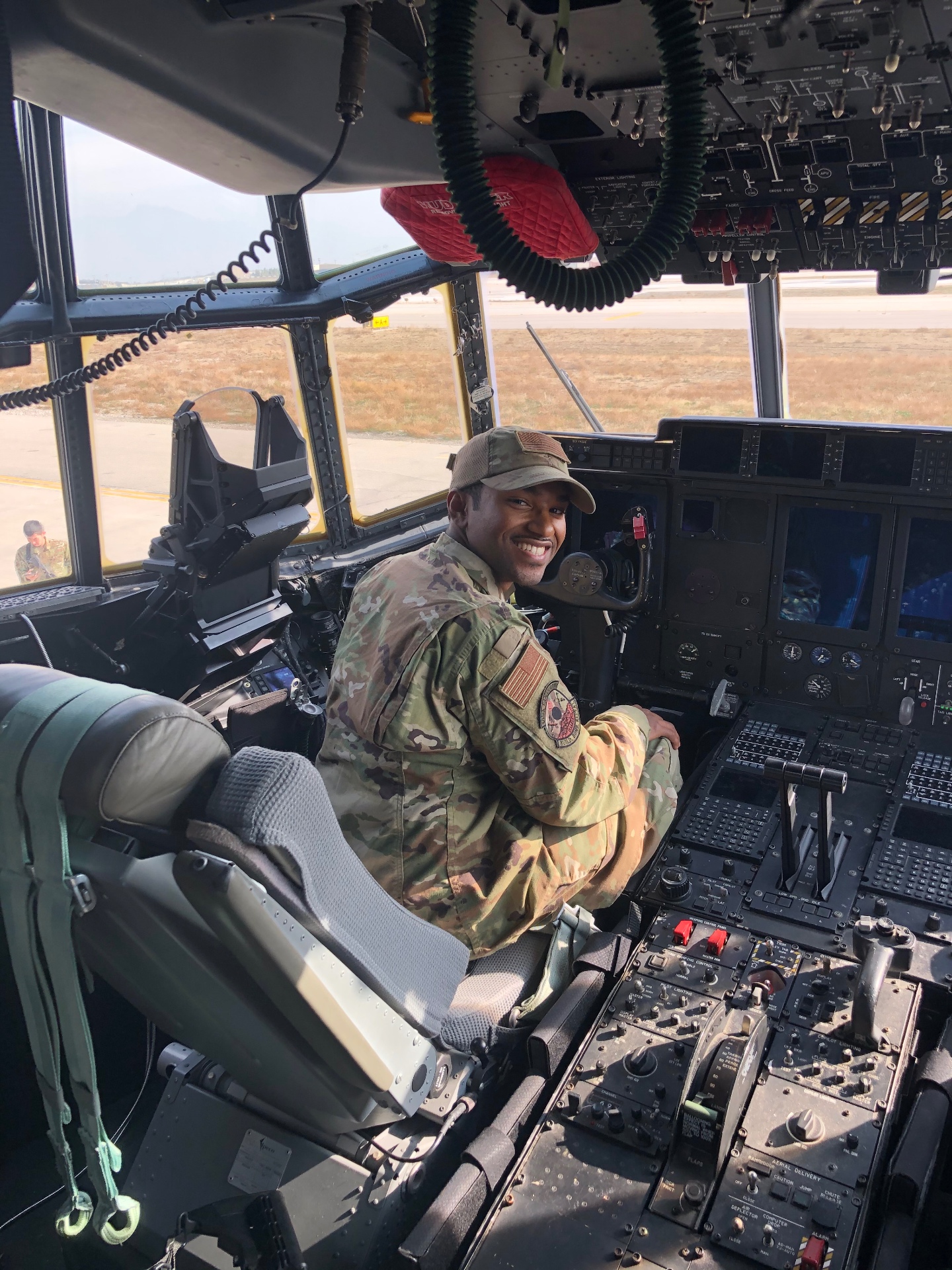 Nexus founder in uniform seated in the cockpit of a military aircraft