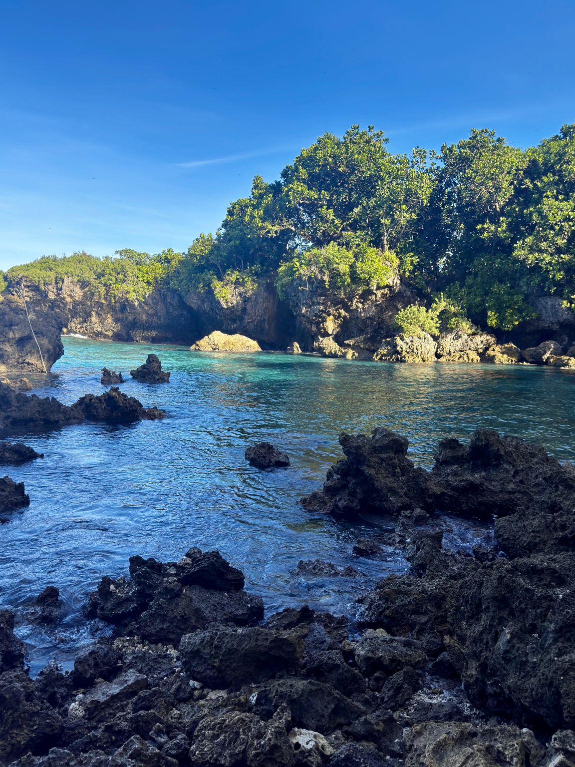 Rocky coastal cove with turquoise water in Guam